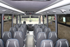 (Interior seating of Iveco school minibus with seat belts and AC vents [de])